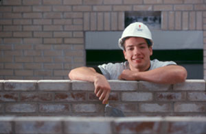 Masonry student working and smiling