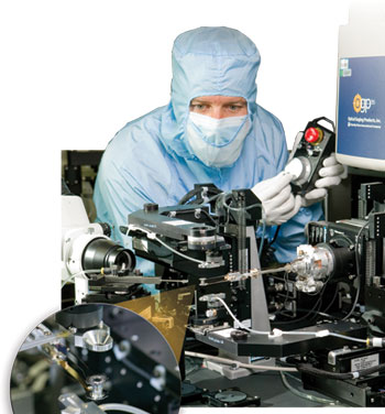 Photo of Richard Montesnti with the precision robotic assembly machine. Inset photo shows a fusion ignition target. 