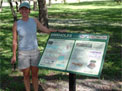 Ann Tihansky stands next to the Geopark sign