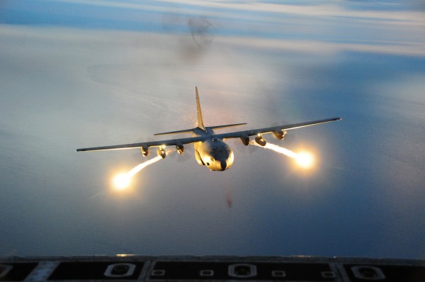 C-130 Hercules cargo aircraft with the 107th Airlift Wing fires off flares during a night formation training mission.