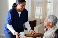 Nurse caring for elderly man