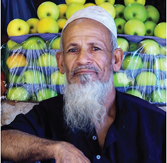 Man in front of apples