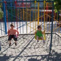 The children enjoy the swings at a newly renovated playground in Ajapnyak