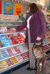 woman with service animal at counter in store