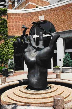 Photo of statue of a hand in front of NOAA