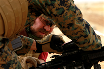 Ted Speers, brother of Capt. Matthew Speers, company commander, Company I, 3rd Battalion 7th Marine Regiment, receives help clearing a double feed from a Marine at the Combat Center’s Range 106 Jan. 24, 2013..