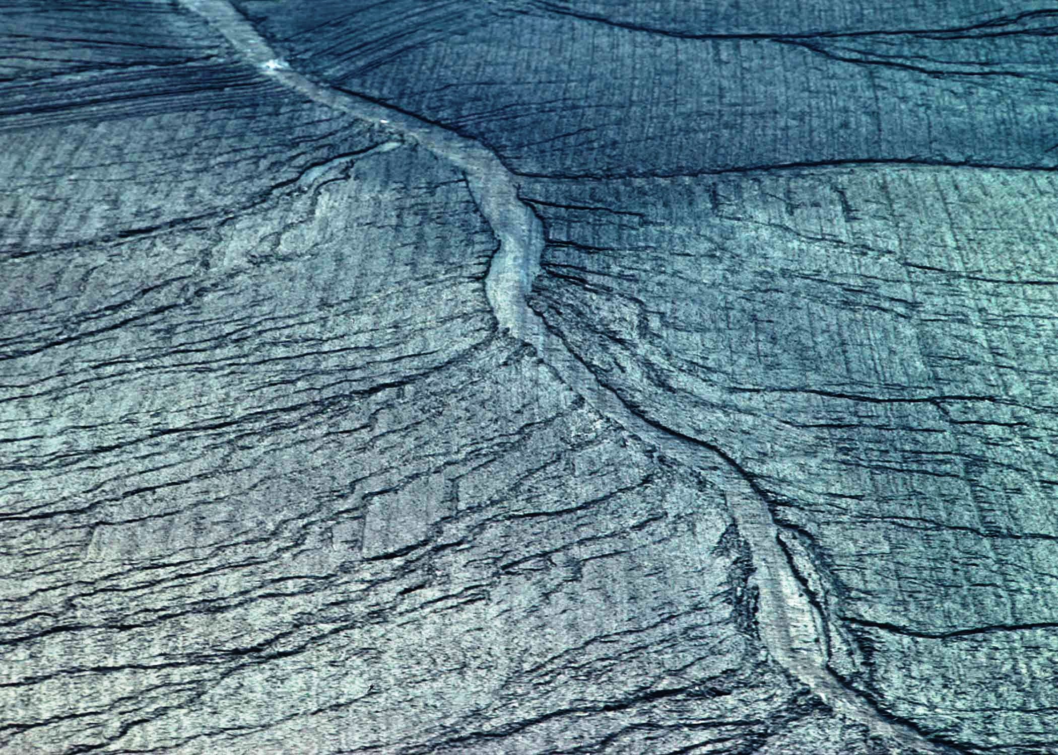 Gray looking cropfield, no vegetation, severe erosion channels