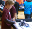 A robotics team member tests the autonomous LEGO MINDSTORM robot the team programmed at the Tulsa FIRST LEGO League qualifying event Nov. 10. About 300 children ages 6 – 14 participated in the event at Memorial High School in Tulsa using robots designed to perform specific functions.