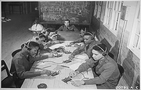 NARA Photo Identifier 535830, "Basic and advanced flying school for Negro Air Corps cadets, Tuskegee, Alabama... In the center is Capt. Roy F. Morse, Air Corps... He is teaching the cadets how to send and receive code.", 01/1942 