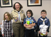 Webelos Scouts pose for a presentation of socks to homeless Veterans