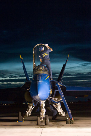 Maintenance crew and F/A 18 Hornet at dusk