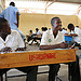 A child sits at a desk in a classroom