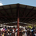 A group of individuals stand underneath a new market roof