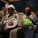 A beneficiary and her baby on a bus