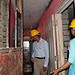 USAID Administrator wears a hard hat and tours a building