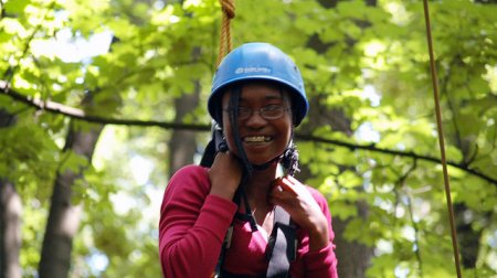 Anita smiles proudly when completing a challenging high ropes course during her exchange.