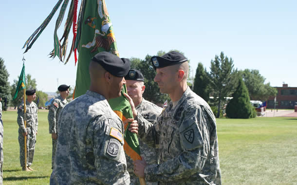 Soldiers exchanging a flag