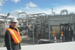 Professor Jack Brouwer, Associate Director and Chief Technology Officer of the National Fuel Cell Research Center, points out the tri-generation facility that uses biogas from Orange County Sanitation District’s wastewater treatment plant to produce hydrogen, heat and power. | Photo courtesy of the Energy Department.