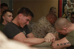 Staff Sgt. Tim K. Pinney (left), staff non-commissioned officer-in-charge, Marine Mobile Air Traffic Control Team, Marine Medium Helicopter Squadron 364,  arm wrestles Lance Cpl. Joshua J. Serrano, mortarman, 81mm Mortars/Tactical Recovery of Aircraft and Personnel Platoon, Weapons Company, Battalion Landing Team 3/5, both with 15th MEU, during an arm wrestling competition held on the troop mess decks of the USS Peleliu, Feb. 6. The rules for the arm wrestling tournament involved one untimed round per opponent. The goal of each match was to pull down on the other person's arm until their wrist hit the table. The 15th MEU is deployed as part of the Peleliu Amphibious Ready Group as a U.S. Central Command theater reserve force, providing support for maritime security operations and theater security cooperation efforts in the U.S. 5th Fleet area of responsibility. Pinney, 27, is from Stafford, Va., and Serrano, 22, is from Chicago. (U.S. Marine Corps photo by Cpl. John Robbart III/Released)