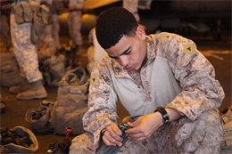 Lance Cpl. Richard L. Cervoni, automatic rifleman, 1st Platoon, Kilo Company, Battalion Landing Team 3/5, 15th Marine Expeditionary Unit, fills a magazine with blank ammunition in the hangar bay of the USS Peleliu in preparation for a training exercise, Dec. 16. The raid was a part of the sustainment training the 15th MEU was conducting in Djibouti. The 15th MEU is deployed as part of the Peleliu Amphibious Ready Group as a U.S. Central Command theater reserve force, providing support for maritime security operations and theater security cooperation efforts in the U.S. 5th Fleet area of responsibility. Cervoni, 20, is from Pawtucket, R.I. (U.S. Marine Corps photo by Cpl. John Robbart III)