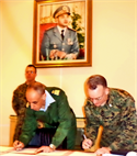 Moroccan Royal Armed Forces Col. Maj. Brahim Hassani lead planner for African Lion 13 and Col. Roger Garay, AL-13 Task Force commander, sign the official minutes in the RAF headquarters in Agadir, Morocco, Jan. 30, confirming the planning for the multi-national exercise scheduled for April.  AL-13 is a U.S. African Command-sponsored, MFA-led exercise that involves various types of training including command post, live-fire and maneuvering, peace keeping operations, an intelligence capacity building seminar, amphibious operations, aerial refueling/low-level flight training, as well as medical and dental assistance projects.