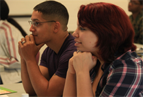 Lance Cpl. John Cotto, left, an aviation technician with Marine Medium Tiltrotor Squadron 165 and a Springfield, Mass., native, and Justina Cotto, Marine spouse, listen to a brief during a Prevention Relationship Enhancement Program class at the Base Chapel here, Feb. 7.  During PREP, couples spend the day learning new communication techniques and ways to keep negativity out of their communications.