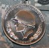 When a Soldier is inducted into the Sergeant Audie Murphy Club, he/she is given the medallion above which is approximately 2 inches in diameter.