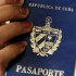 A woman holds up a Cuban passport in a regional immigration office in Havana (Cuba).