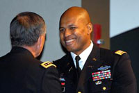 Vice Chief of Staff of the Army Gen. Peter Chiarelli congratulates top U.S. graduate Maj. Anthony Gore, recipient of the Gen. George C. Marshall Award, during the Command and General Staff College graduation for the 2011-02 Intermediate Level Education class Dec. 16 at the Lewis and Clark Center. Chiarelli provided remarks at the ceremony. 
