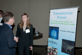 A woman presents to audience members at a conference about transatomic power: turning nuclear waste into electric power.