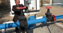 Sabur, above, diligently turns the wheel of the new irrigation system to water h