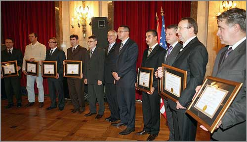 A group of men holding certificates