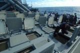 A sailor aboard the guided missile destroyer USS Fitzgerald (DDG 62) inspect the MK 41 Vertical Launching System (VLS) for water to prevent electrical failure.