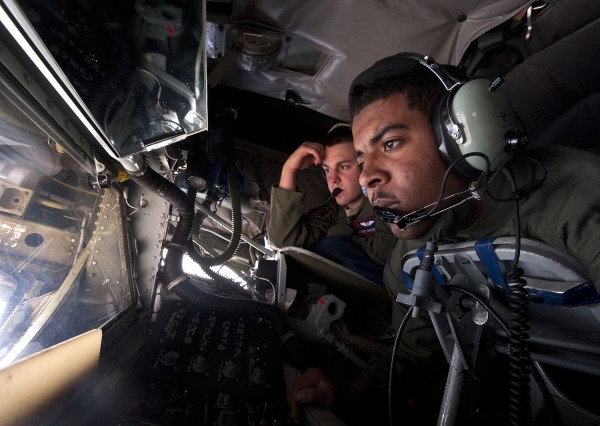Airman 1st Class Adrian Snelson (foreground) waits to refuel an aircraft over Nevada as Staff Sgt. Cody Beverly evaluates during the Green Flag-West 13-02 exercise.