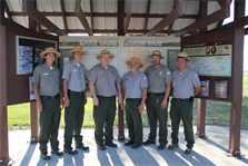 Oahe Park Rangers stand in front of a visitor information pavilion constructed as part of an Eagle Scout project.