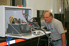 NSSL researcher adjusts the equipment on a mobile mesonet vehicle in the field