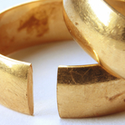Image of a wedding ring, with part of it missing.