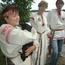 Volha Makhanenka, a coordinator of a regional greenway, is engaging tourists into the Harvest Granddad rite that seeks to appease the field and the harvest god.