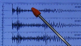 Official of Japan's earthquake agency points at graph of ground motion waveform data observed Feb. 12, 2013 from North Korean nuclear test