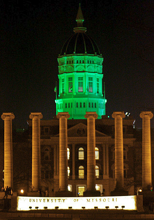 Campus gossip every year spreads the rumor that the first time Jesse Hall was it green, a group of engineers has broken into the lightning controls and altered them as a prank for Engineering Week. The school changes the color voluntarily now. Click through for image source.