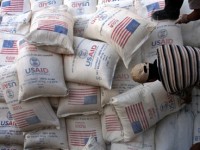 Palestinians unload bags of flour donated by USAid at a depot in the West Bank village of Anin near Jenin. Photo Credit: Mohammed Ballas/AP.