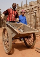 Man pushing wheelbarrow