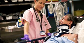 C-STARS student Staff Sgt. Susanne Fry comforts her patient Ed Hubur while he is being transferred into the shock trauma center after he was injured in a fall. (U.S. Air Force photo by Tech. Sgt. Bennie J. Davis III)