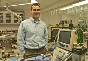 Dr. Jeffrey R. Capadona proudly stands in his research lab