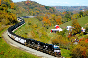 A fully loaded coal train winds through scenic Appalachia