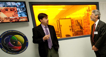 Director of the Institute for Nanoscience at the NRL, Dr. Eric Snow, briefs Director of the White House Office of Science and Technology Policy, Dr. John P. Holdren, during a tour of NRL.