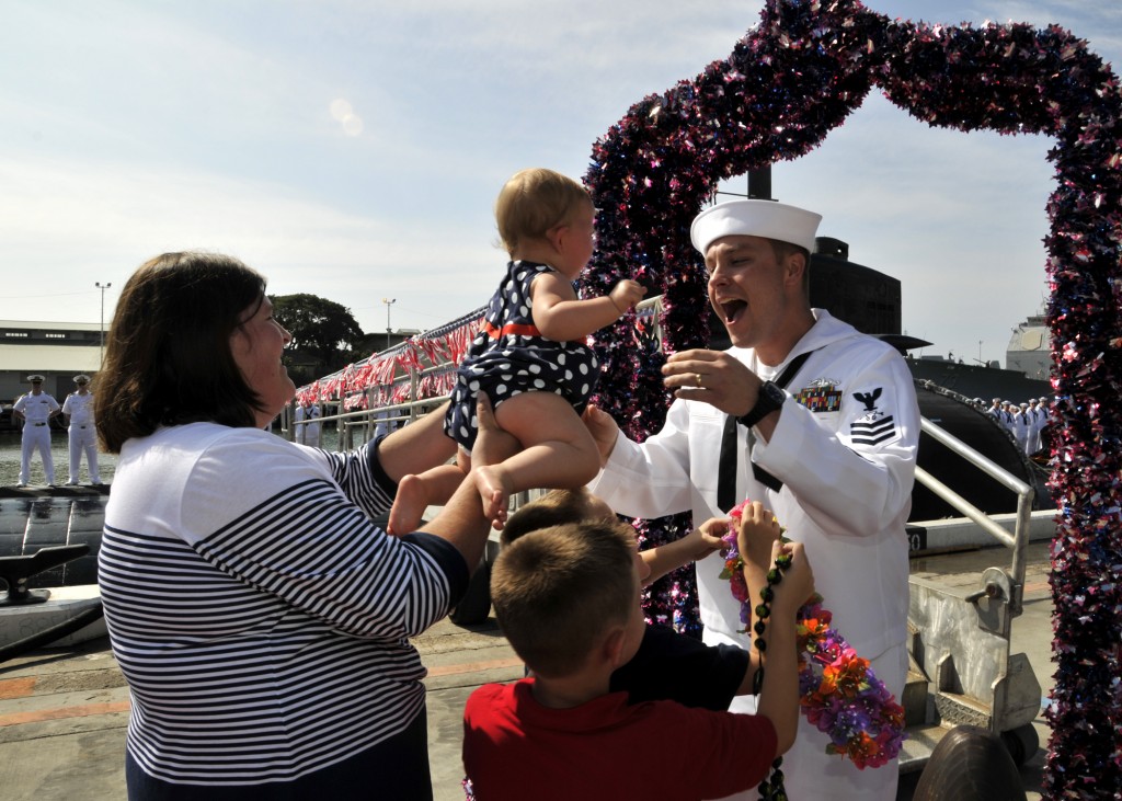 Sonar Technician (Submarines) 1st Class Jeff Wansart runs to his family for the first hug following the return of the Los Angeles-class attack submarine USS La Jolla (SSN 701) to Joint Base Pearl Harbor-Hickam after completing a six-month deployment to the western Pacific region, Jan. 25, 2013. (U.S. Navy photo by Mass Communication Specialist 2nd Class Steven Khor/Released)
