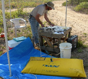 A USGS scientist prepares a tracer solution in a gas-tight bladder