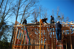 Marines and volunteers cover a roof with plywood during a Habitat for Humanity volunteer project in New Bern Saturday. Every two weeks the Single Marine Program takes Marines to the build site where the service members get their hands dirty building homes for families.