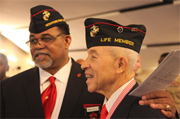 Edmund Brookins, a member of the Cherry Point chapter of the Montford Point Marine Association, poses for a photo with Master Sgt. Johnnie Thompkins Jr., one of the first African Americans to enlist in the Marine Corps , during a ceremony commemorating the service of the first enlisted African American Marines,  at the Marine Corps Air Station Cherry Point Theater, Friday. Thompkins recalled enduring hardships and prejudices during his time in the service but said he did not let those obstacles stop him. He retired after serving more than 20 years in the Marines.